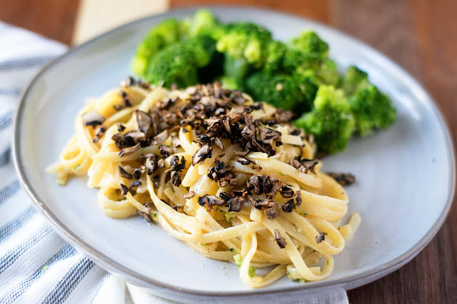 The finished Vegan Carbonara with mushroom bacon bits and a side of steamed broccoli on the side.