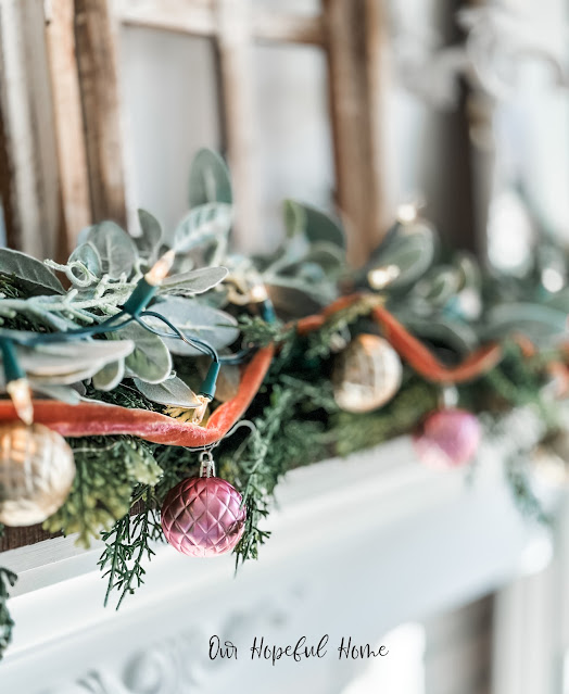 velvet ribbon Christmas ornament garland draped over mantel