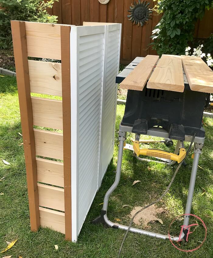 How to hide unsightly outdoor house vents with repurposed wooden louvered bifold doors into a DIY outdoor bar table plus BBQ grilling utensil holder.