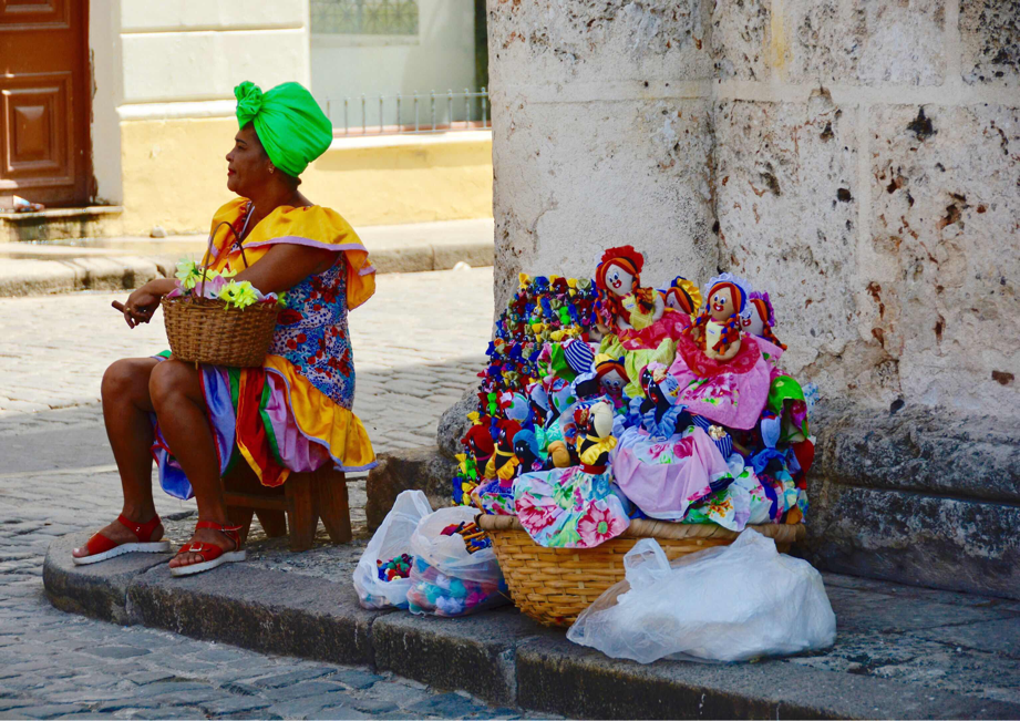 Lady in costume smoking cigar in Havana Cuba