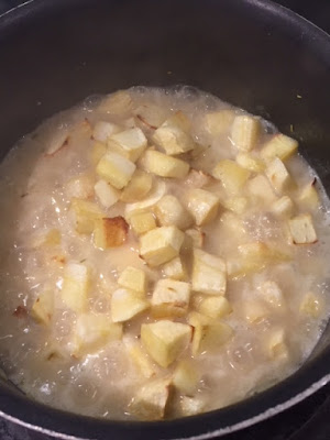 Roasted parsnip on top of bubbling risotto in a pan