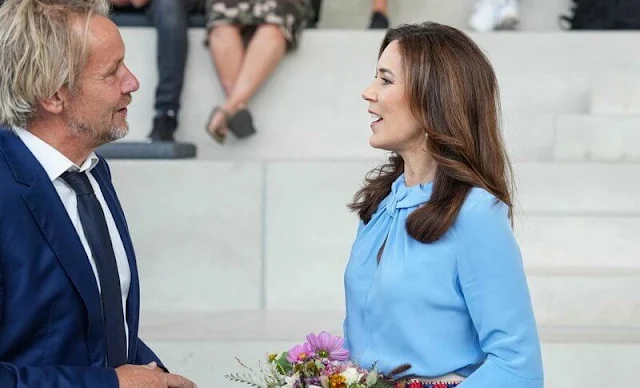 Crown Princess Mary wore a flare sleeve knot blouse by Victoria Beckham, and an ivory silk skirt by Birger et Mikkelsen