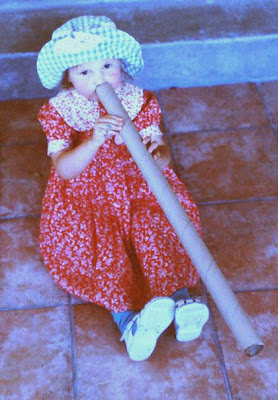 Catriona, playing a tune on a cardboard tube.