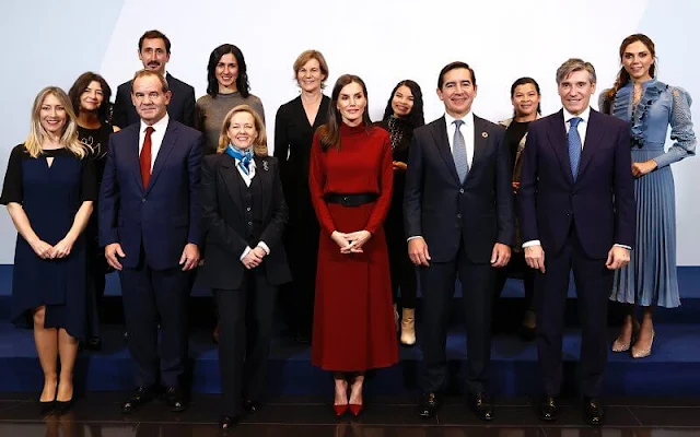 Queen Letizia wore a burgundy, maroon, wine red, high neck open-back dress by Massimo Dutti. Black coat