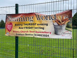 A sign the says Slimming World with a cup of chips on it.