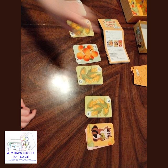 Clumsy Thief Junior game cards and game in action with A Mom's Quest to Teach logo