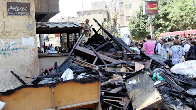 Christians remove objects from a burned church in the working-class neighborhood of Imbaba in Cairo on May 8
