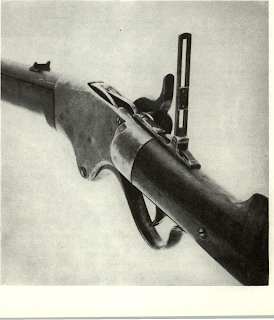 Special Spencer sporting rear sight is unique pattern with these rare arms, does not have large disc peep so characteristic of sights of following decade. Gun is listed in 1866 catalog but is believed to date from early in the war. Flange on butt plate is end of loading tube which, turned aside, is pulled out to insert seven cartridges into magazine. Design was heavy, but foolproof. The loading tube (not shown) is carried in a recess in the stock, and inserted through the butt plate.