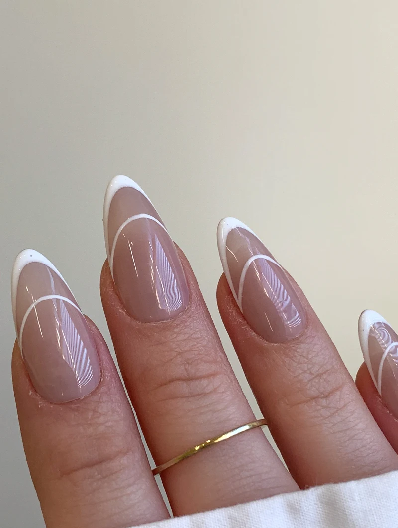 close-up of a ebautifully manicured woman's hand with a french tip design