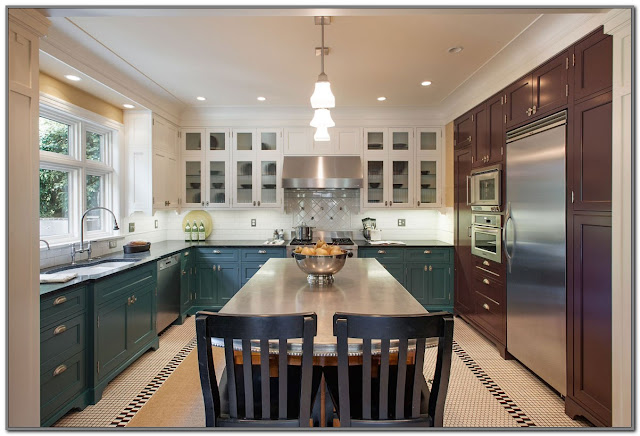 blue kitchen cupboards with black countertops