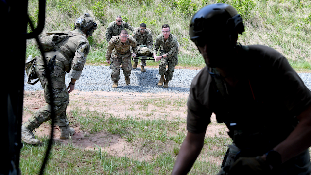 The USU GSN students took part in the Trauma Culmex training exercise held in conjunction with The FBI's elite Hostage Rescue Team on May 17 in Quantico, Va. Here, students rush their simulated patient onto a Black Hawk helicopter. (Photo credit: Ian Neligh, USU)