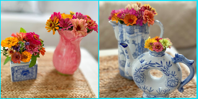 four porcelain vases filled with zinnias