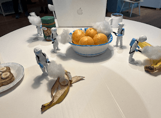 clay figures disinfecting fruit on a kitchen table