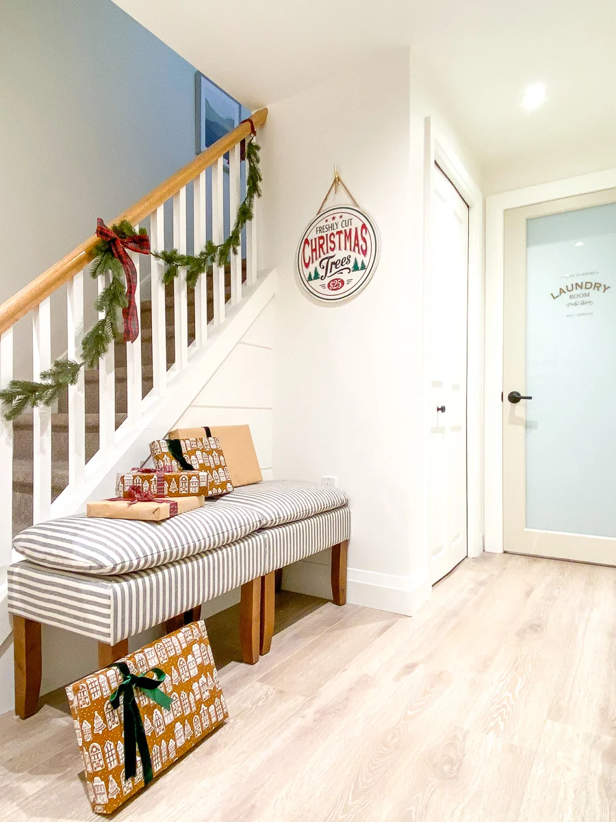 basement stair landing with garland and ottomans