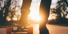 Close-up of Leg and Sneakers on Skateboard