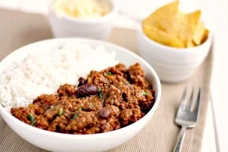 Slow Cooker Chilli Con Carne with rice and grated cheese