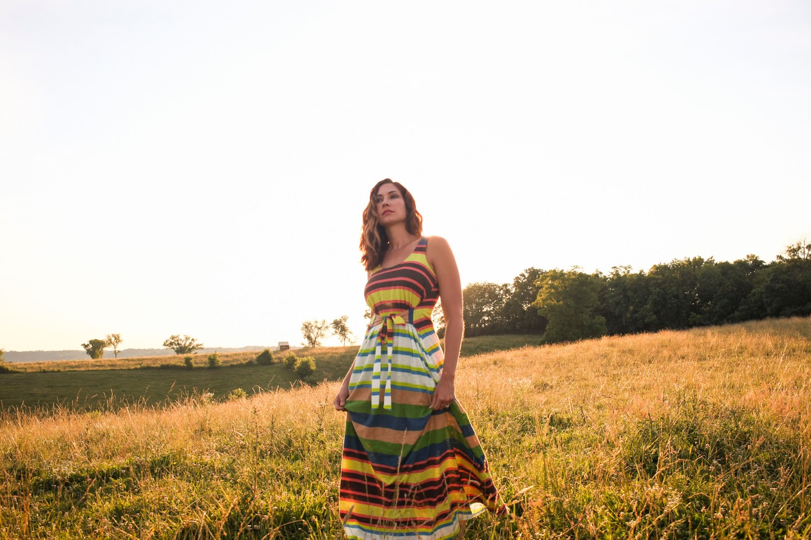 Amy West walks through the hills of Kentucky in a colorful maxi dress