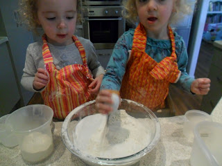 Stirring sugar and baking powder with flour for rainbow cake.