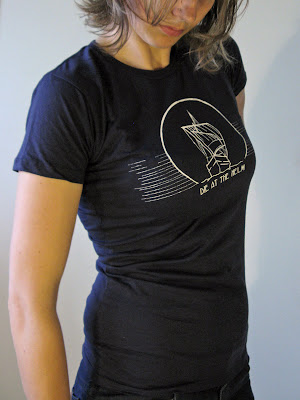 A portrait of Aramee Diethelm wearing a tshirt that she designed and hand screen-printed.