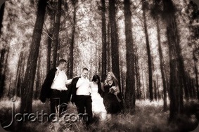 Bride and groom with wedding party in a forest - Joretha Taljaard Wedding Photography