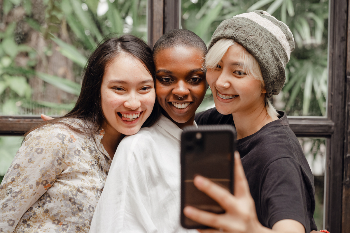 three women taking selfie with smartphone