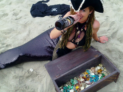 mermaid shelly drinking rum as a mermaid pirate by vintagemermaidsociety.blogspotcom