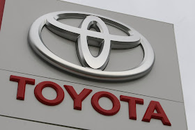 huge toyota logo stands at a car dealership