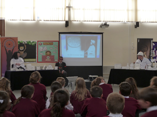 A performance taking place at one of the fifteen schools.