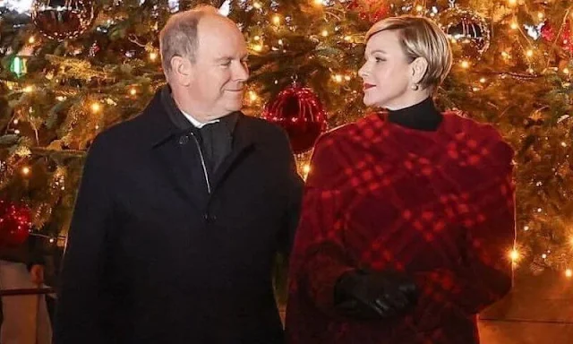 Princess Charlene wore a red ripple check draped coat by Burberry. Princess Stephanie and Melanie de Massy