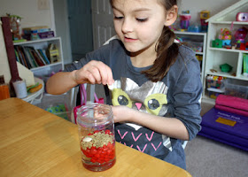 Tessa poured corn syrup, red hots, lentils and lima beans into a clear plastic jar to create the blood model. Each item represents a component of blood (corn syrup = plasma, red hots = red blood cells, lentils = platelets, lima beans = white blood cells).