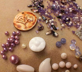 Into the forest elements: purple, white, and silver beads in various mediums (glass, ceramic, metal, glass pearls, mother of pearl) and teeny-tiny seed beads, along with a tree ceramic focal by Marla James :: All Pretty Things