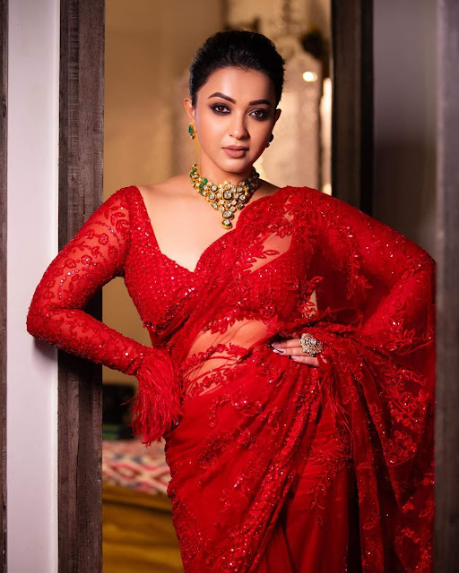 Koushani Mukherjee looking ravishing in a red saree, showcasing her hot photoshoot stills with confidence and grace.