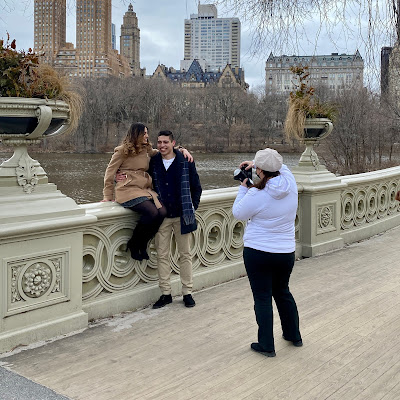 Photographer taking a photo of a couple on Bow Bridge