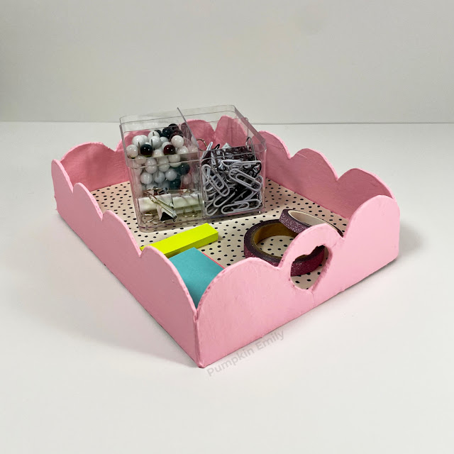 A pink tray made out of cardboard.