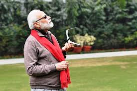 Modiji watching sky with goggles.