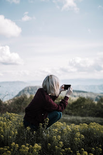 A women taking photo of nature with smartphone.