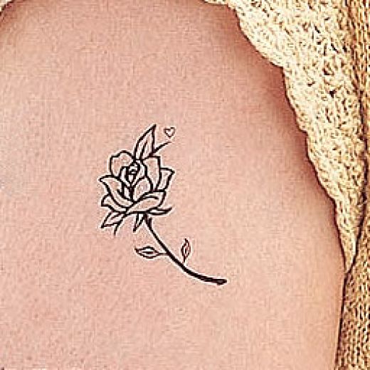 Nice and plain tiny lil black rose tattoo not sure if I like it