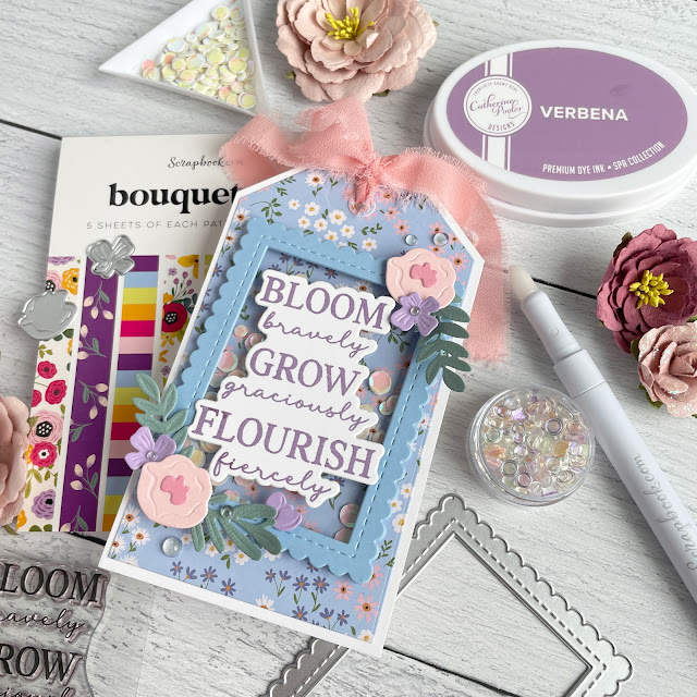 Spring floral tag inspired by SBC Fest Laura Graff class; created with Build-a-Bouquet die, Grow with the Flow die, Nested Scalloped Frame die, Spellbinders Color Wheel Cardstock, Sizzix Muted Surfacez, Prima ribbon and Pinkfresh Iridescent Dew Drops.