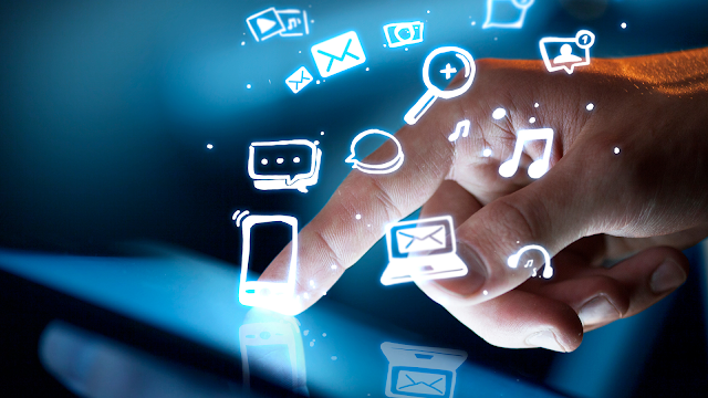 A finger touching a screen with icons of different media surrounding the finger