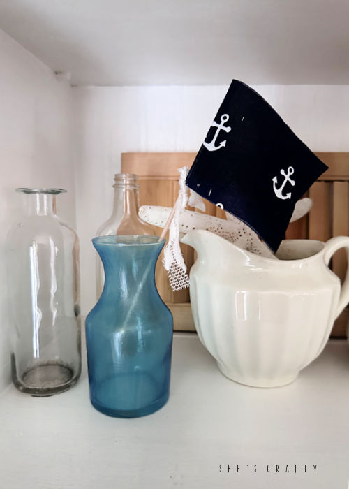 Anchor flag in sea glass vase.