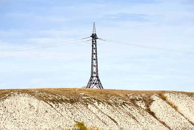 high-voltage-line-and-electricity-pylon-on-coastline-of-river