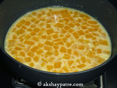 thick cocnut milk with jaggery added -preparing pumpkin kheer