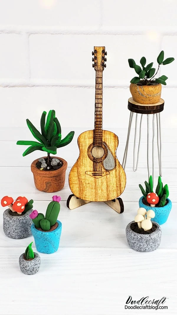 How to Make a Miniature Acoustic Guitar Studio!  This miniature guitar studio is one of my most favorite projects to date.   I love how this tiny little acoustic guitar turned out.   I love that mini hairpin leg stool.   I mostly love these little clay potted plants! 😉 😂