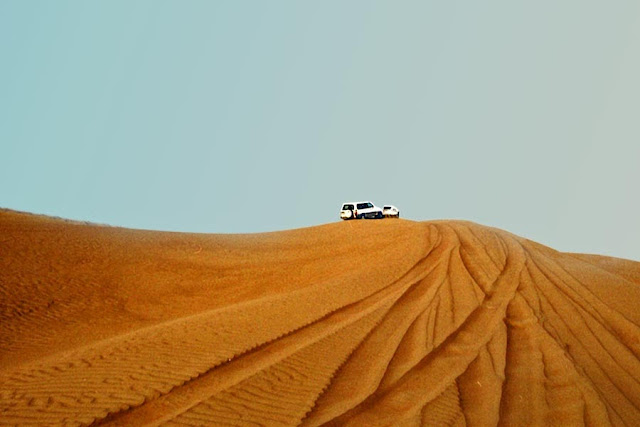 tourist jeep on the sand dunes in dubai