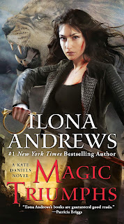 A woman in black with a leather jacket and long, dark hair draws a sword from her waist. A lion roars behind her.