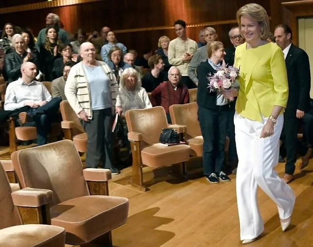 Queen Mathilde wore a lemon yellow top by Natan, and white trousers by Natan Couture. Queen Elisabeth International Music Competition