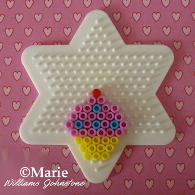 Star shaped pegboard with cake beaded design