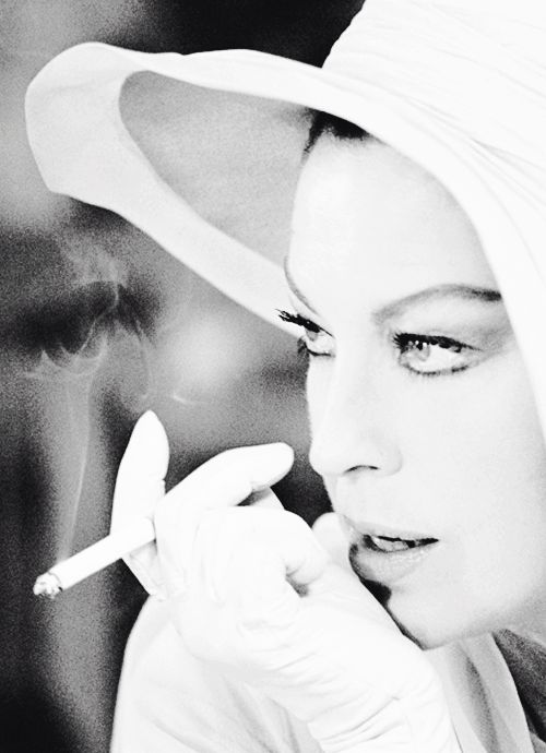 Ava Gardner in profile closeup photo with white hat and cigarette