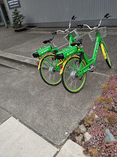 Two LimeBikes parked in the only wheelchair accessible part of the entryway