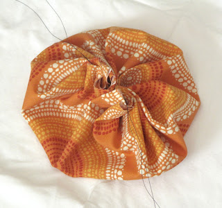 DIY spiced fabric pumpkins fall centerpieces - pull the thread tight to make a pouch